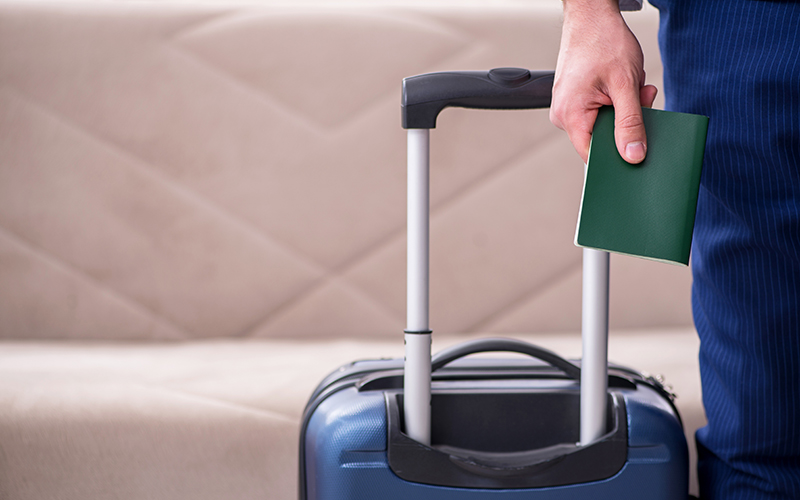 Young businessman holding passport preparing for trip